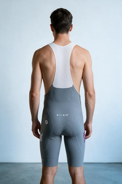 False Flat x Castelli cool grey bib shorts with white mesh back, purple details, and aerodynamic Forza2 fabric.